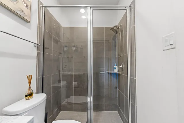 a bathroom with a shower and toilet