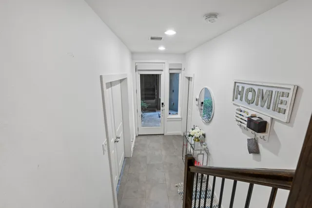 a kitchen with stainless steel appliances granite countertop a table chairs stove and refrigerator