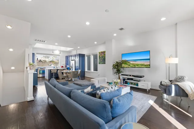 a bedroom with a bed and a view of living room