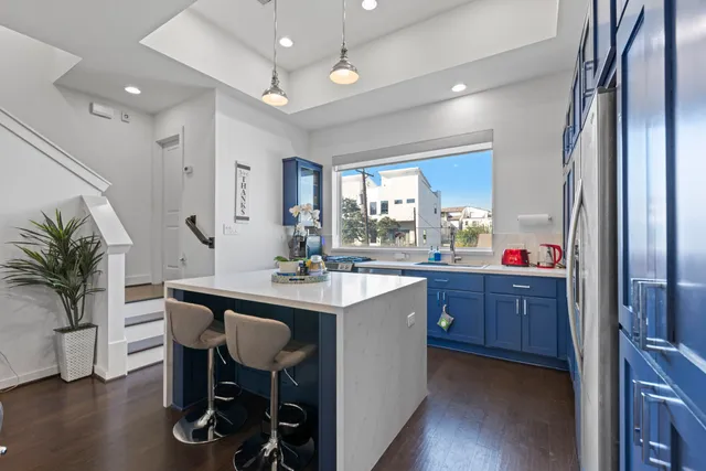 a kitchen with sink and refrigerator
