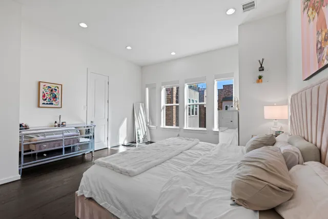 a spacious bedroom with a bed and a walk in closet