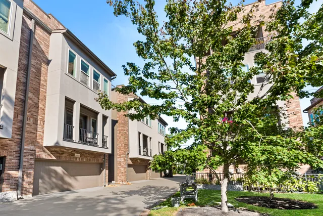 a spacious bedroom with a bed and a painting on the wall