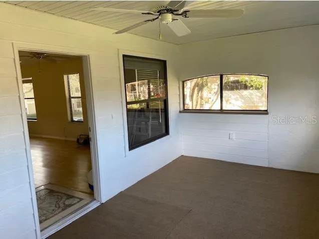 an empty room with windows and closet