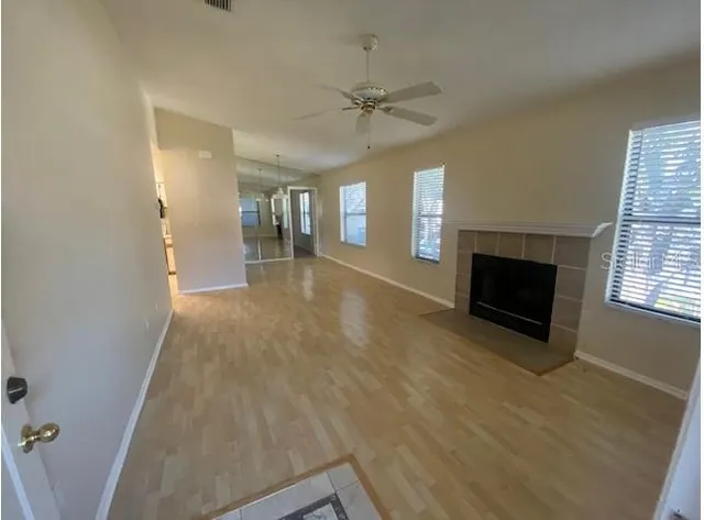wooden floor in an empty room with a fireplace