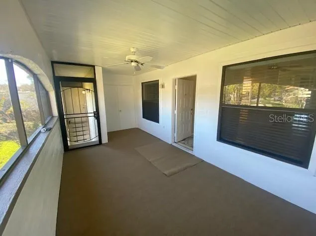 a view of an empty room with a fireplace and a flat screen tv