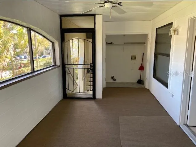 a view of a hallway with wooden floor and entryway