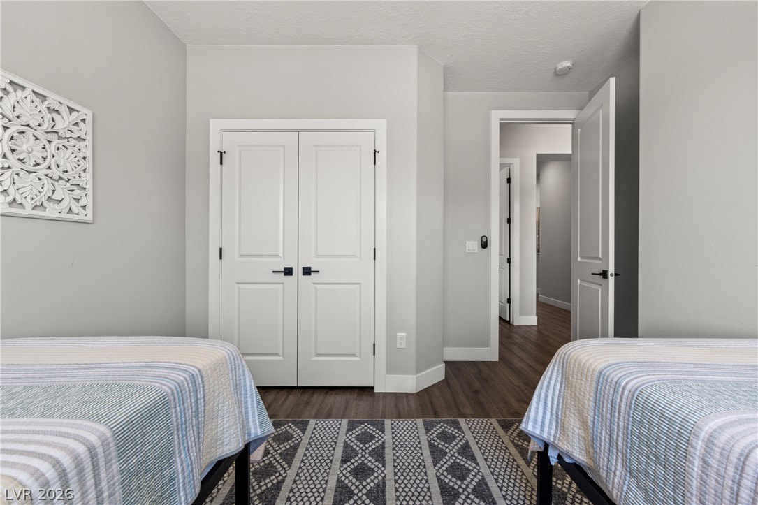 1436 Manassas Ridge Mesquite, NV 89027 - Photo 8 of 77 Well-appointed bedroom showcasing durable flooring and ample closet space.