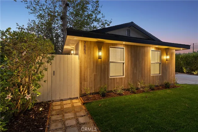 a view of a house with a yard and a garden