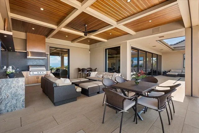 a outdoor space with couches a fireplace and a counter top space