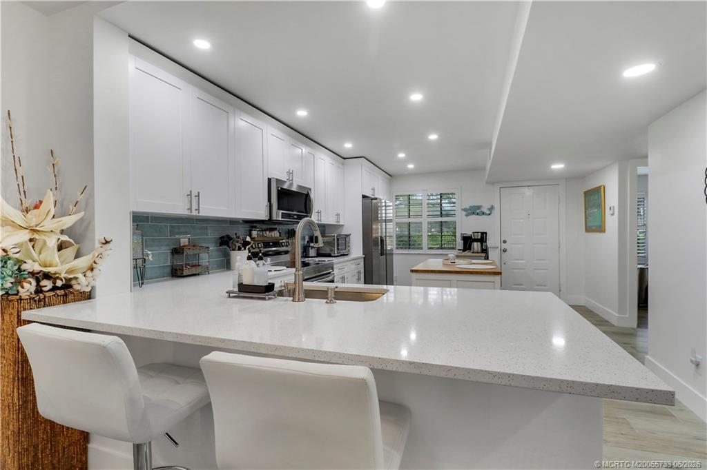 1001 Keystone Drive, Unit A Jupiter, FL 33458 - Photo 6 of 30 a view of kitchen with stainless steel appliances large counter top space