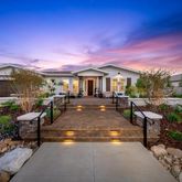 a view of a house with swimming pool and sitting area