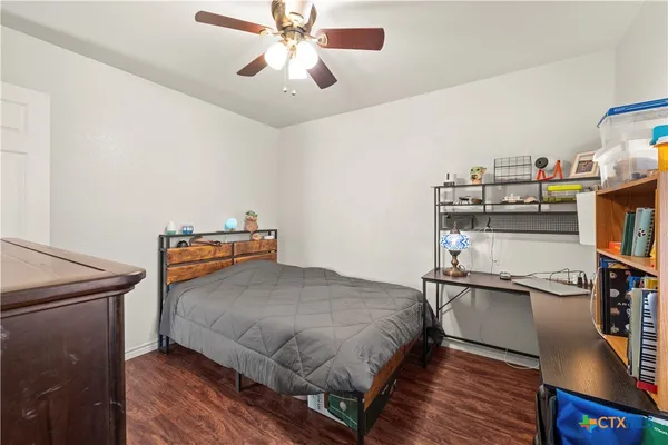 a bedroom with a bed and a bookshelf