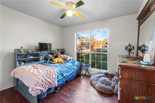 a bedroom with bed and a window