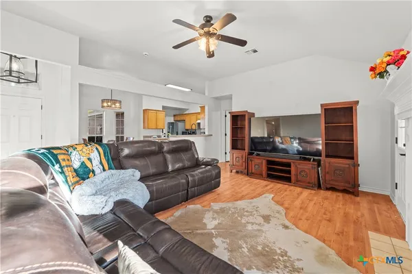 a living room with furniture and kitchen view