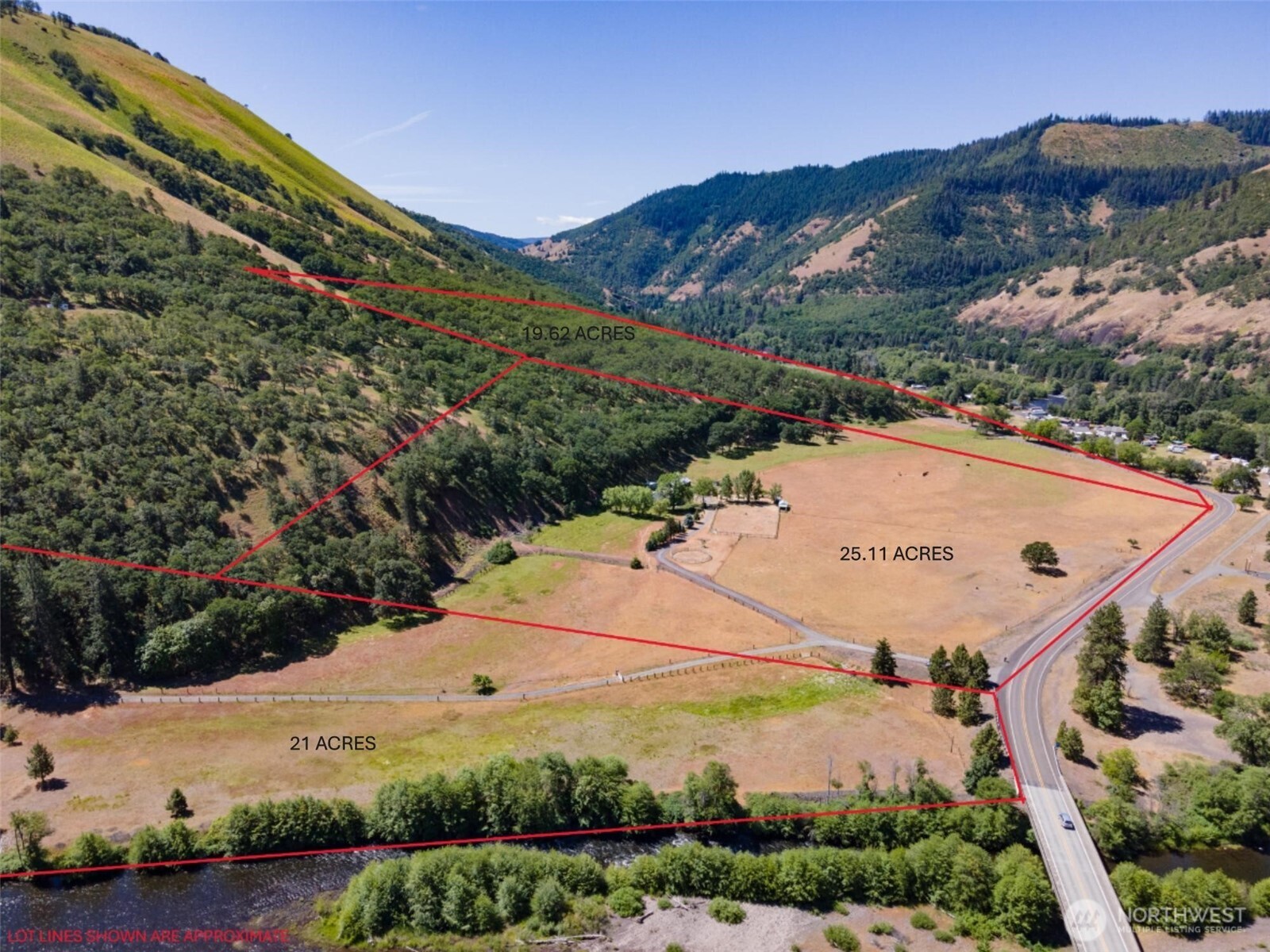 992 Highway 142 Lyle, WA 98635 - Photo 1 of 40 an aerial view of residential houses with outdoor space and trees