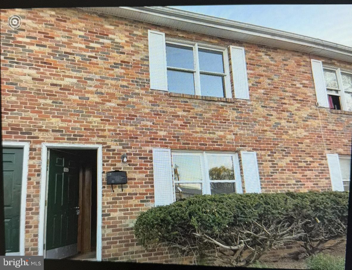 a front view of a brick house with a small space