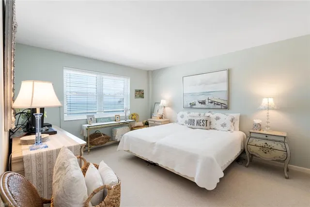 a bedroom with double bed and a window