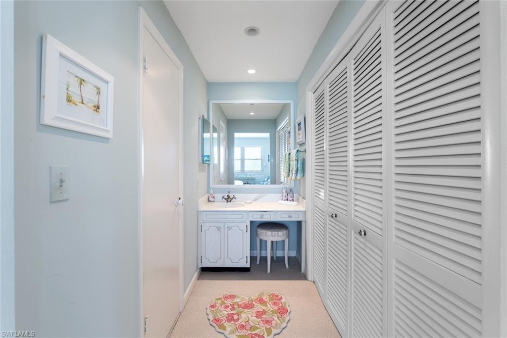 2011 Gulf Shore Boulevard North, Unit 45 Naples, FL 34102 - Photo 13 of 16 a bathroom with a sink and a mirror