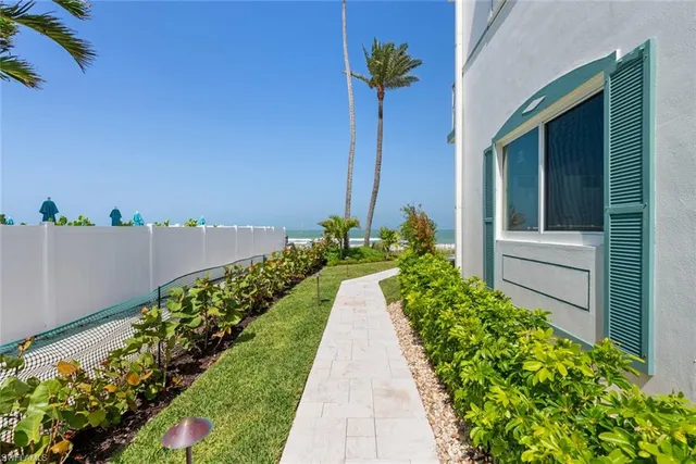 a view of a pathway with a flower garden