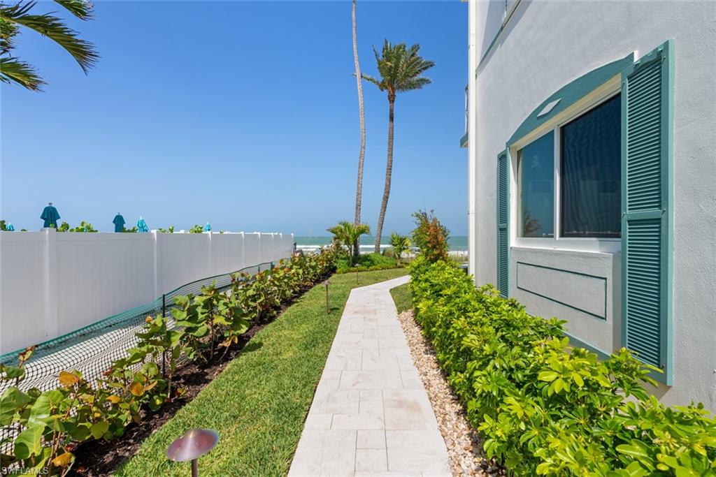 2011 Gulf Shore Boulevard North, Unit 45 Naples, FL 34102 - Photo 15 of 16 a view of a pathway with a flower garden