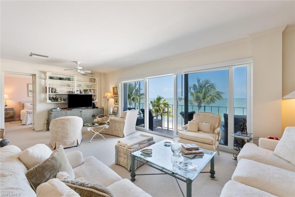 2011 Gulf Shore Boulevard North, Unit 45 Naples, FL 34102 - Photo 2 of 16 a living room with furniture and a large window