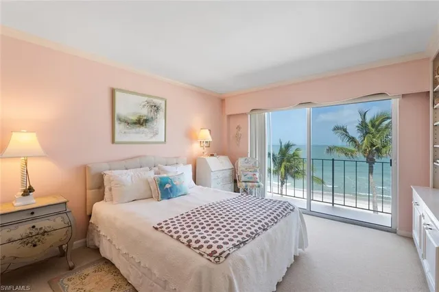 a bedroom with a large bed and a lamp