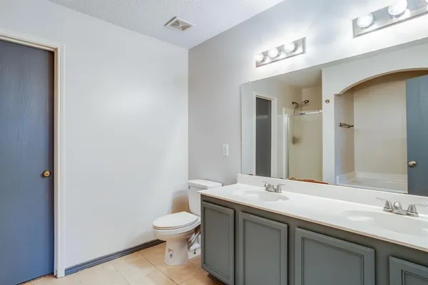 an empty room with ceiling fan and window