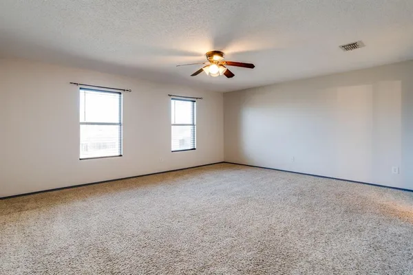 a view of an empty room with windows