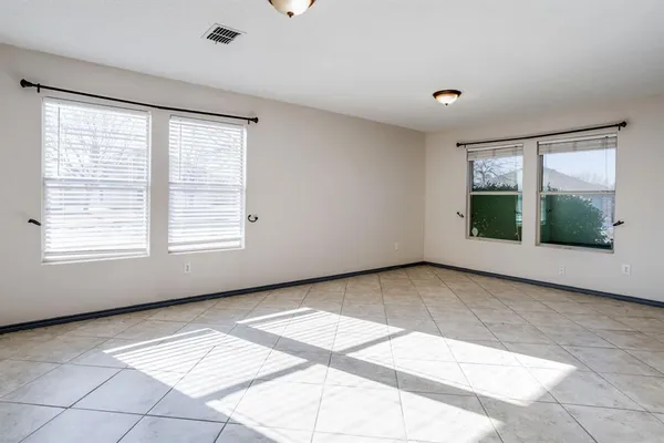 a view of an empty room with a fireplace and a window