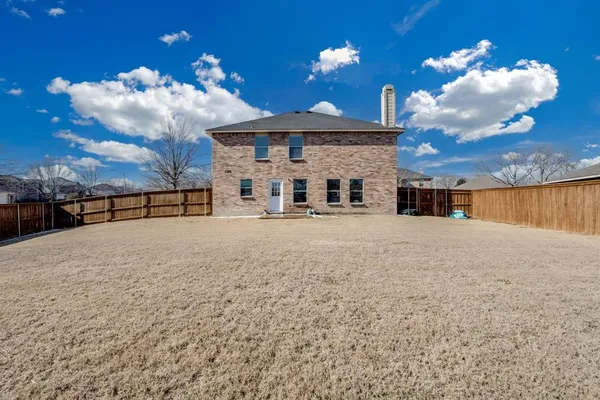 a kitchen with granite countertop a stove sink and microwave