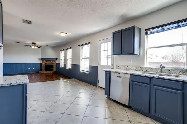 a kitchen with stainless steel appliances granite countertop a stove sink and cabinets