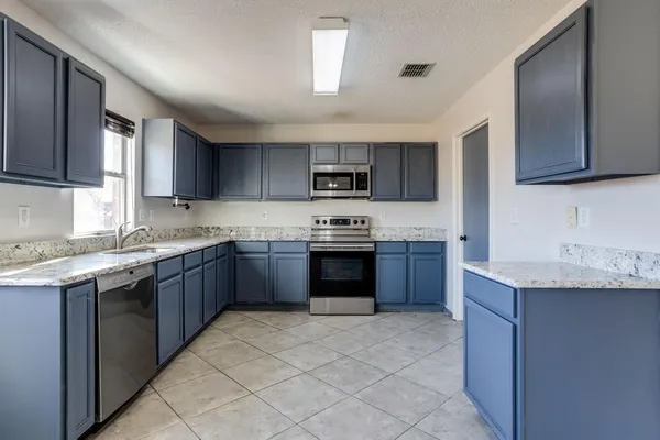 a view of a storage and utility room with racks on the wall