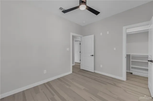a view of an empty room and wooden floor