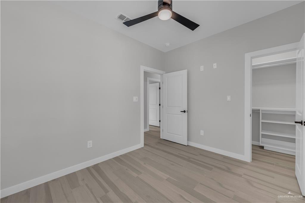 11411 North 24th Lane, Unit A McAllen, TX 78504 - Photo 10 of 24 a view of an empty room and wooden floor