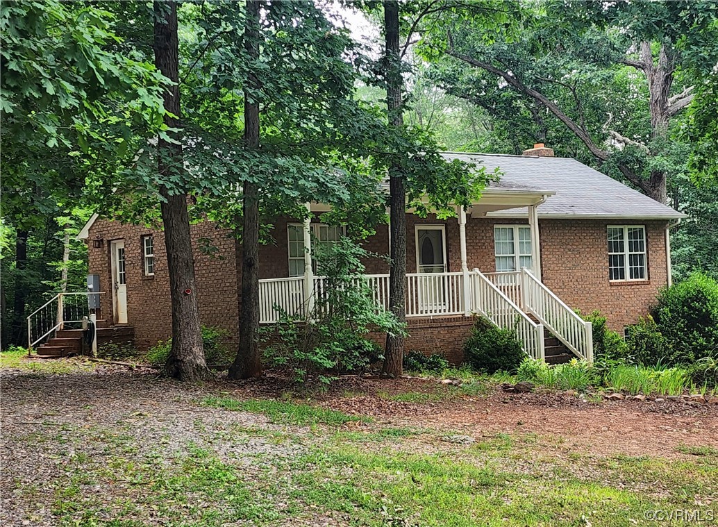 5920 Community House Road Columbia, VA 23038 - Photo 1 of 19 a front view of a house with garden