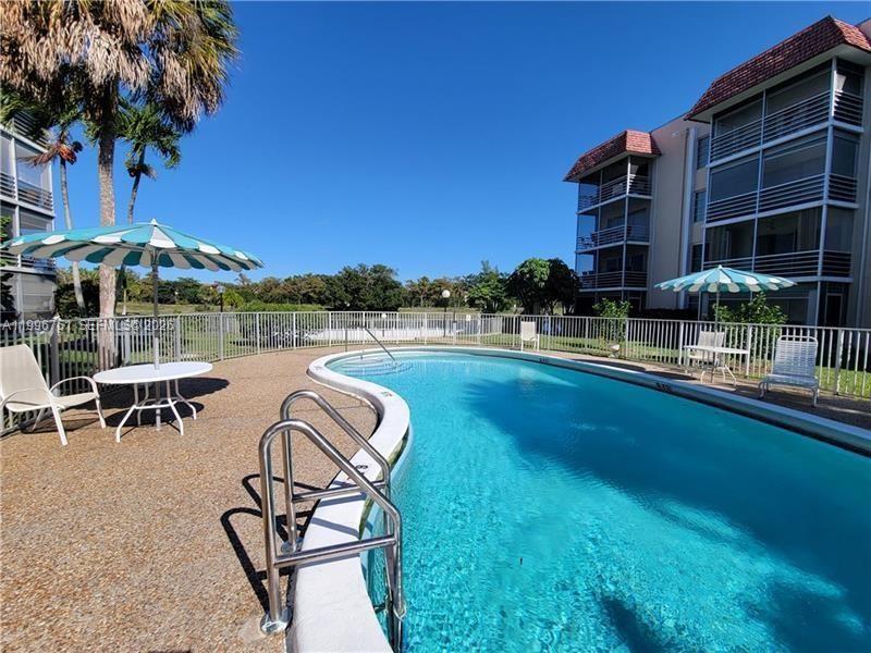 3774 Inverrary Boulevard, Unit 206P Lauderhill, FL 33319 - Photo 17 of 17 a view of a swimming pool with a lounge chair