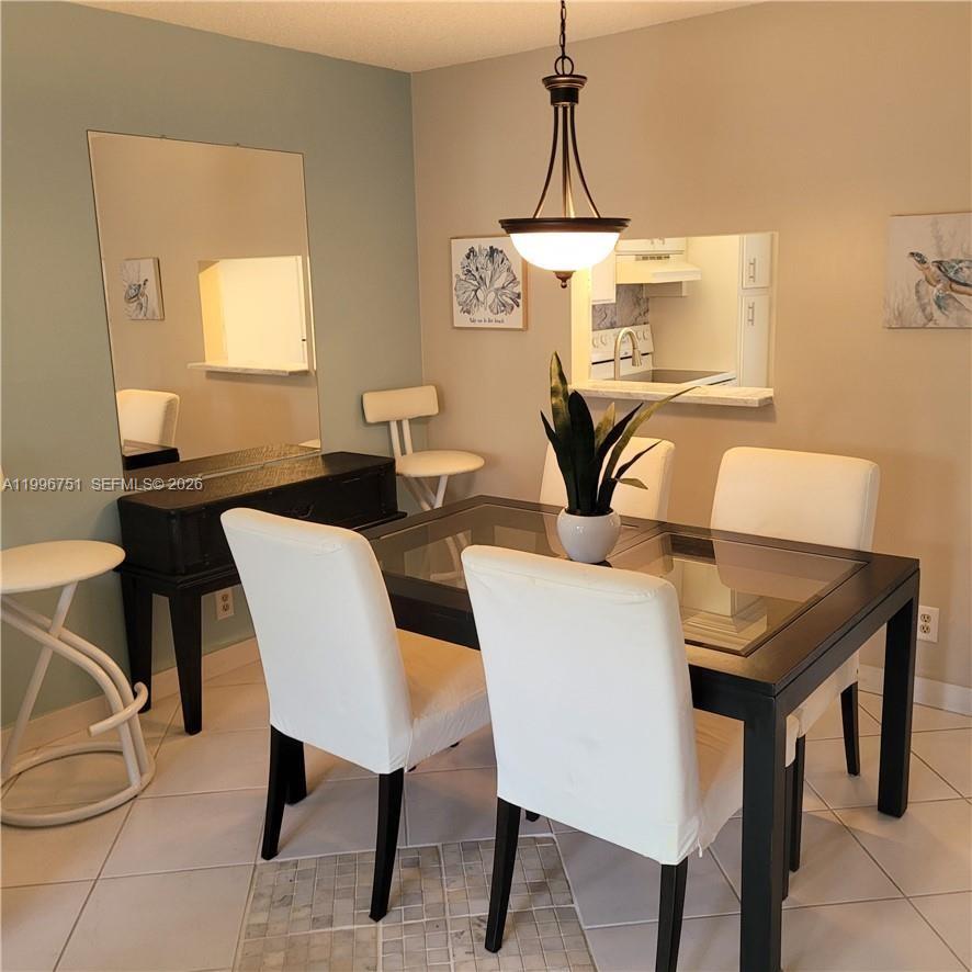 3774 Inverrary Boulevard, Unit 206P Lauderhill, FL 33319 - Photo 3 of 17 a view of a dining room with furniture