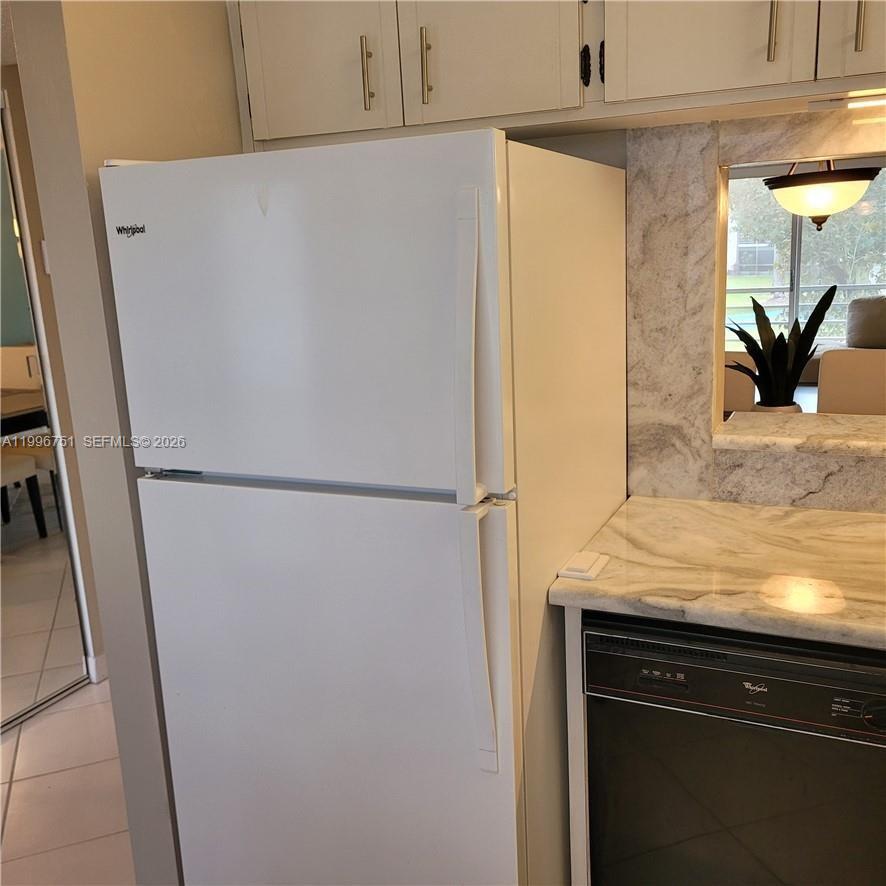 3774 Inverrary Boulevard, Unit 206P Lauderhill, FL 33319 - Photo 6 of 17 two white refrigerator freezer sitting in a kitchen