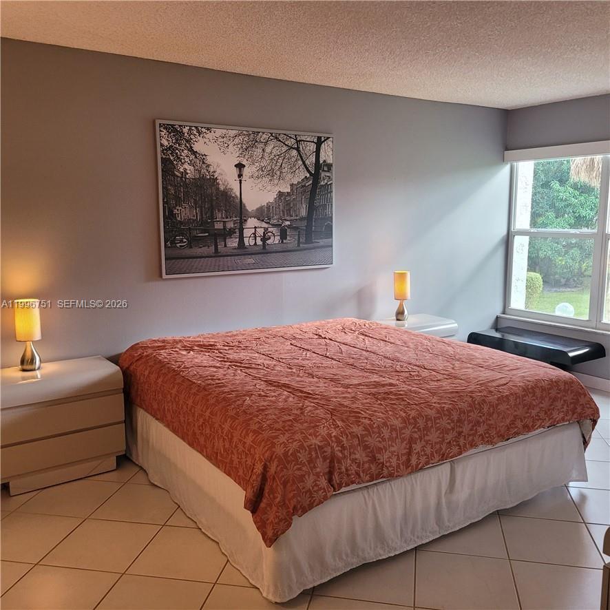 3774 Inverrary Boulevard, Unit 206P Lauderhill, FL 33319 - Photo 9 of 17 a bedroom with a bed and window