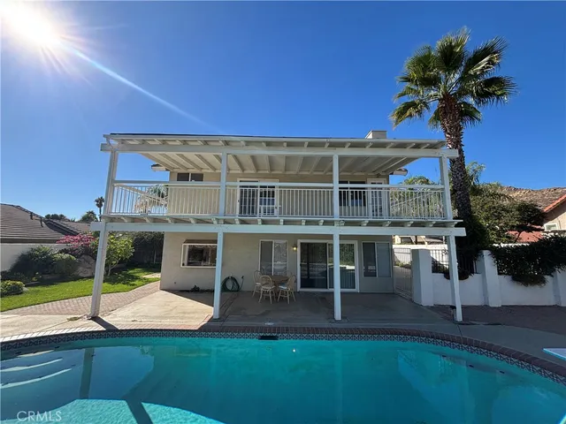 a view of a house with a yard and potted plants