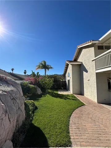 a view of a house with backyard and sitting area
