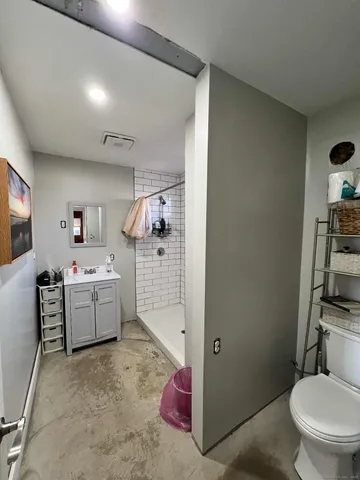 a living room with furniture and a toilet