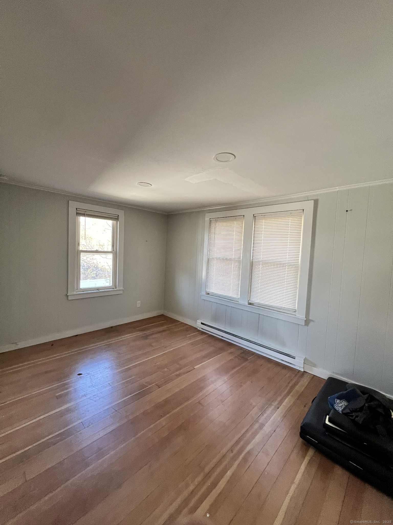 102 Cottage Street Killingly, CT 06239 - Photo 13 of 20 an empty room with wooden floor and windows