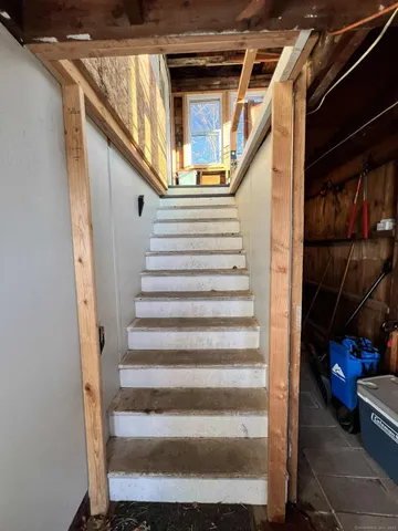 a view of entryway with wooden floor and stairs