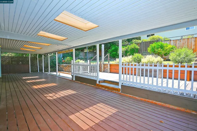a view of a chair and table in backyard of the house