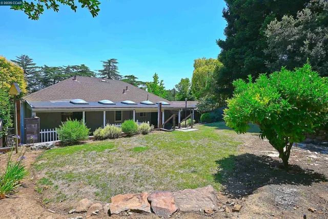 a kitchen with stainless steel appliances granite countertop wooden cabinets stove top oven and sink