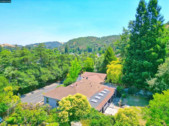 an aerial view of a house with mountain view