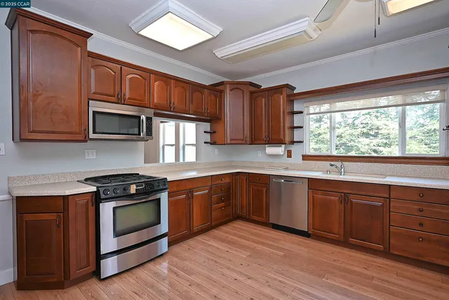 a kitchen with stainless steel appliances a stove and cabinets