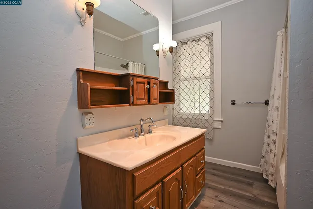 a bathroom with a sink a mirror and shower
