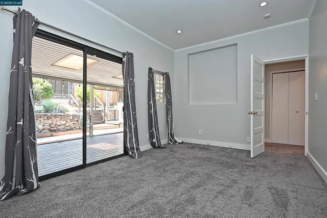 an empty room with a cabinet and a window